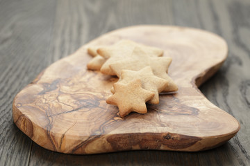 homemade star shape ginger cookies on olive board