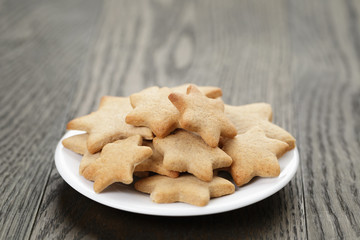 homemade star shape ginger cookies on wood table