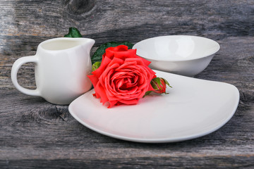 Breakfast pot and plates with fresh pink garden roses