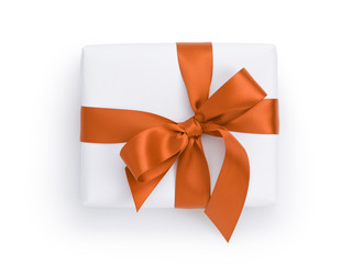 white gift box with orange ribbon bow, from above