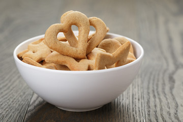 heart cookies for valentines day in white bowl on wood table