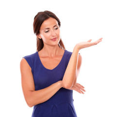 Attractive woman in purple dress holding palm up