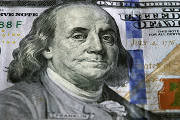 One Hundred Dollars. Selective focus on Benjamin Franklin eyes.