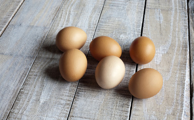 Fresh eggs on rustic wood