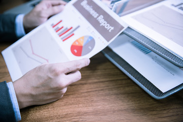 Businessman analyzing investment charts with laptop. Accounting