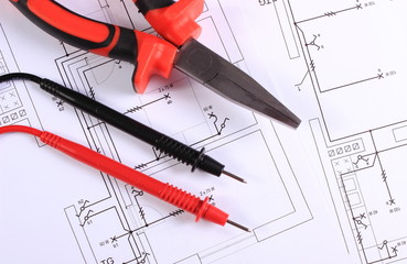 Cables of multimeter and work tool on construction drawing