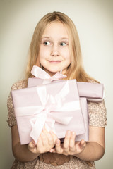 Surprised girl with gift box in her hands