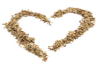 Heart of fresh basil on white background