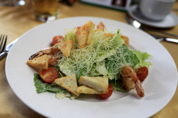 Plate of caesar salad with seafood