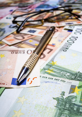 Pen with euro banknotes.