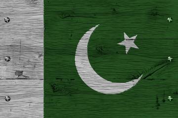 Obraz na płótnie Canvas Pakistan national flag painted old oak wood fastened