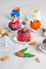 Pieces of bananas in color chocolate with nuts and coconut flake