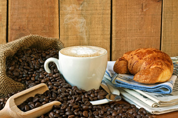 cappuccino, brioches and newspaper with background