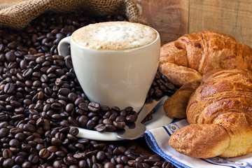 cappuccino, brioches and newspaper with background