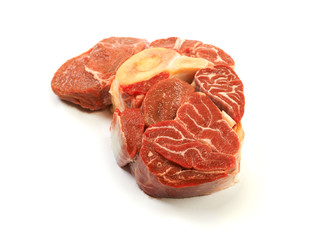 A large piece of red meat with a bone on a white background.