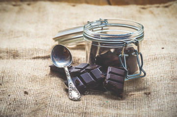 Pieces of dark chocolate in a jar Vintage