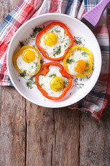 fried eggs with peppers on a pan. top view vertical