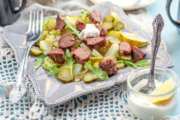 Warm salad with potatoes, pickles and chicken liver