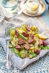 Warm salad with potatoes, pickles and chicken liver