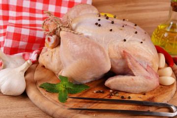 Raw chicken on wooden table