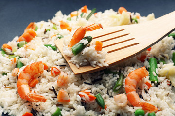 Tasty rice preparing in wok, close-up