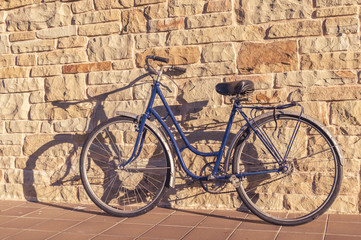 Fototapeta na wymiar Old or classic bicycle on a stone wall