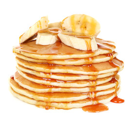 Stack of delicious pancakes with slices of banana and honey