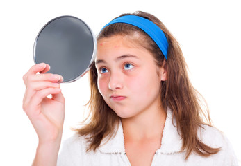 Girl examine her pimples in the mirror