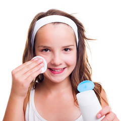 Girl cleaning her face with tonic lotion