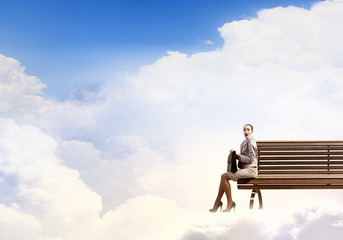 Businesswoman on cloud