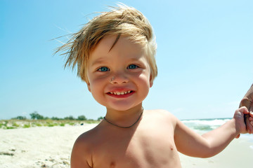Smiling boy on a sea beach