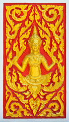 Golden angel sculpture at Thai temple wall