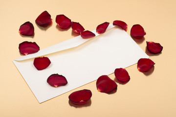 open blank envelope with red leaves in heart shape