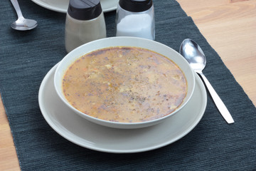 Chitterlings with marjoram soup in white bowl.