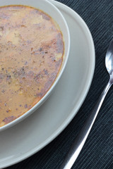 Chitterlings with marjoram soup in white bowl.