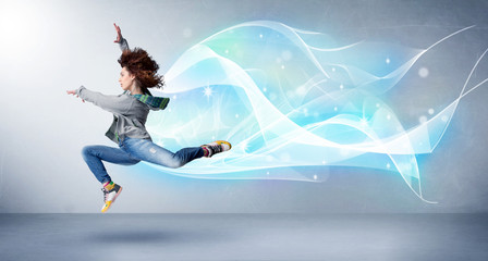 Fototapeta na wymiar Cute teenager jumping with abstract blue scarf around her