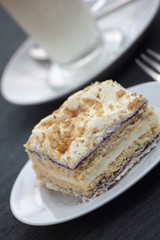 Piece of layered cake on white plate.