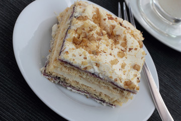 Piece of layered cake on white plate.