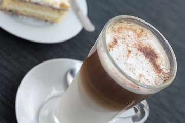 Closeup of cafe latte sprinkled with cocoa.