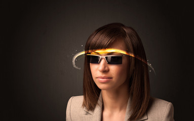 Pretty woman looking with futuristic high tech glasses