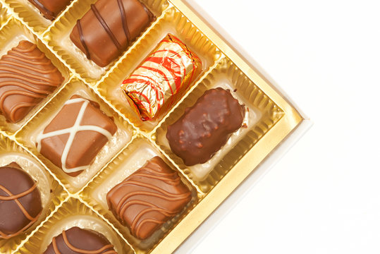 Large box of sweet chokolate candies isolated on white.
