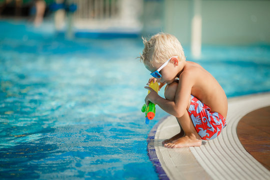 young boy kid swimming in pool