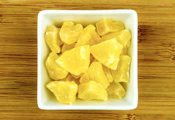 Dried candied pineapple in bowl