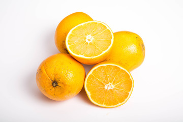 Whole and Half Naval Oranges on White