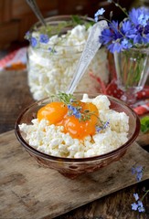 fresh homemade cheese with apricot jam on old wooden table