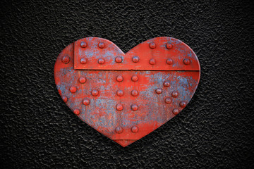 Metal heart on a dark texture