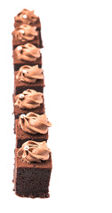 Bite sized chocolate cake with icing on top over white 