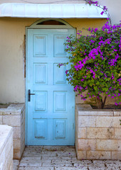 Old blue rustic wooden door and flowers