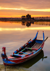 Wooden boat in Ubein Bridge at sunrise, Mandalay, Myanmar