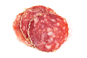 Slices of salami sausage on a white background